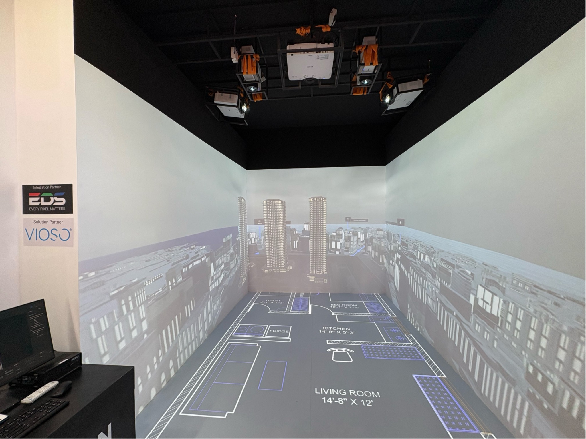 Five-projector immersive room featuring EXAPLAN floor projection and architectural imagery on the walls.