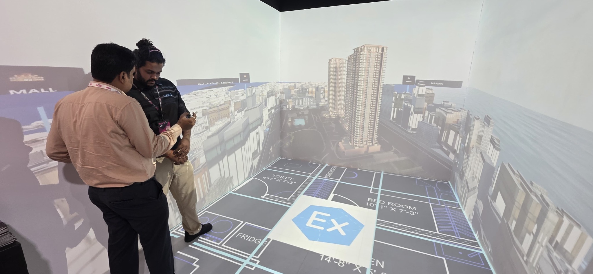 Visitors exploring a full-scale architectural floor plan with VIOSO EXAPLAN.