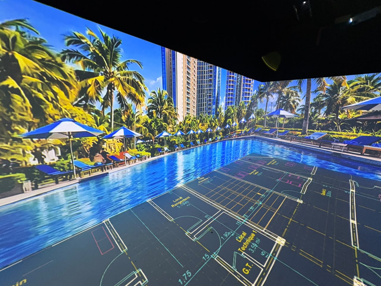 Projected floor plan surrounded by poolside architectural imagery