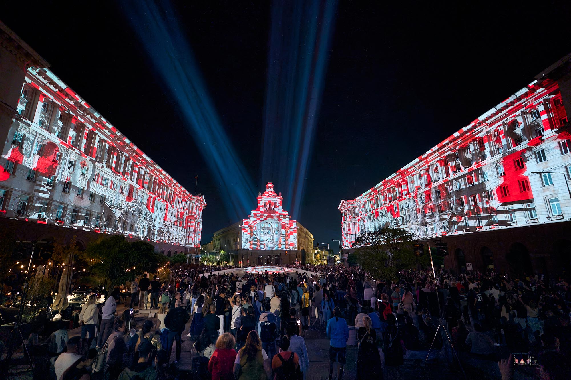 Red and white projections across the Largo with visitors in Independence Square at LUNAR 2026, Sofia