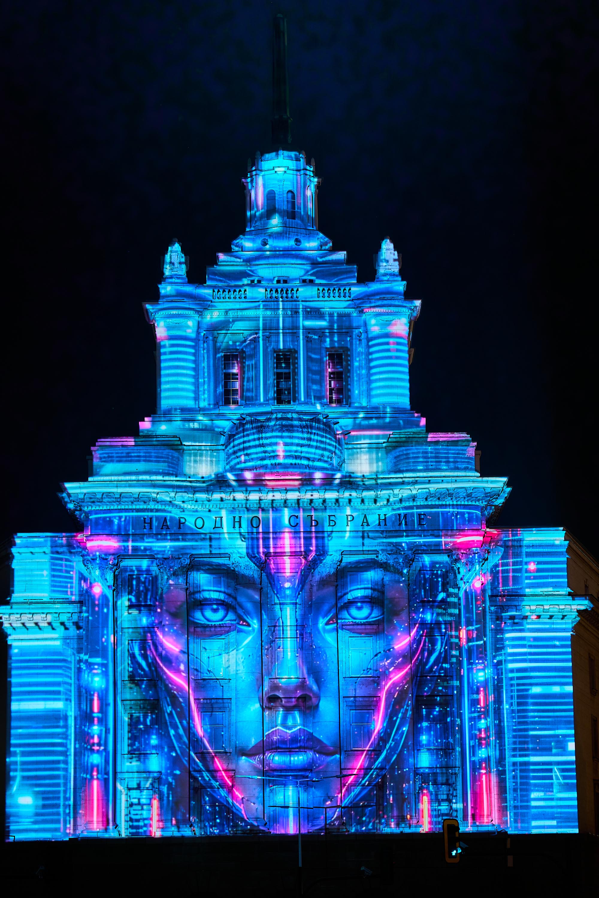 Close view of a blue face projected onto the National Assembly at LUNAR 2026, Sofia